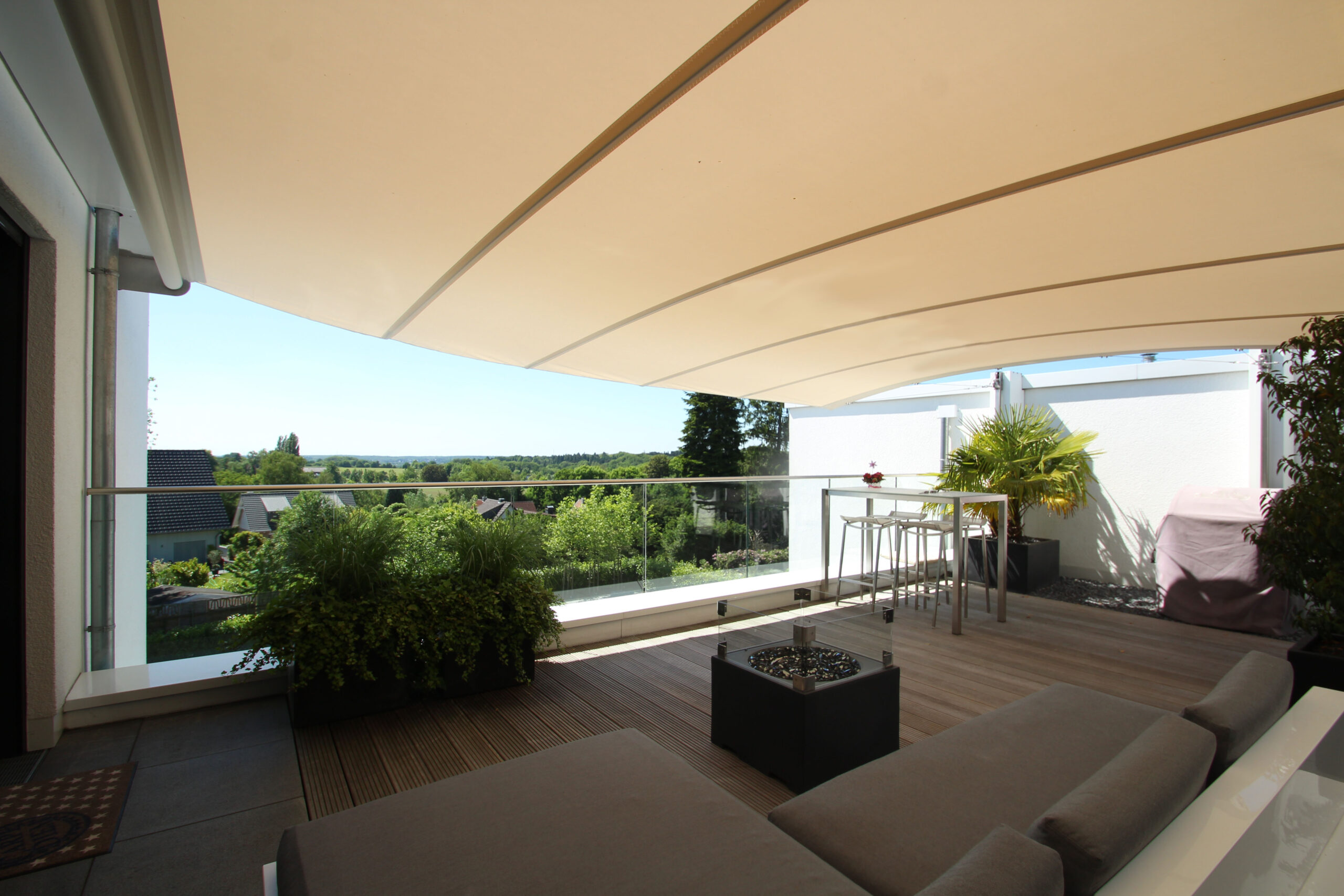 An Öhrra Square retractable shade sail on an exposed roof terrace installation